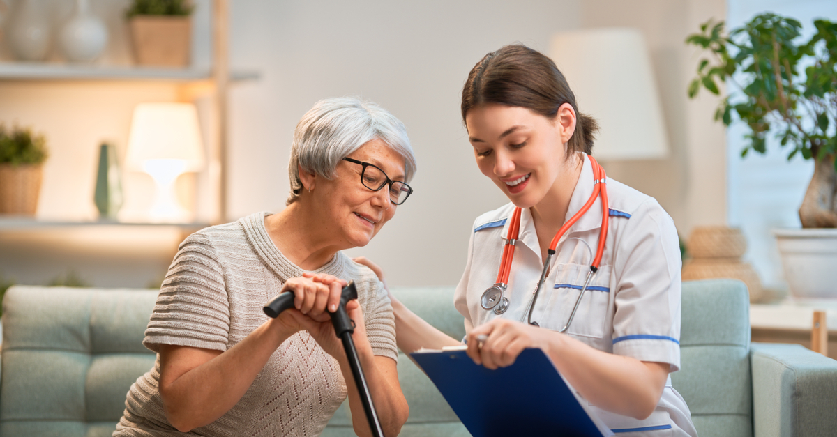 female caregiver with happy senior woman spending time together