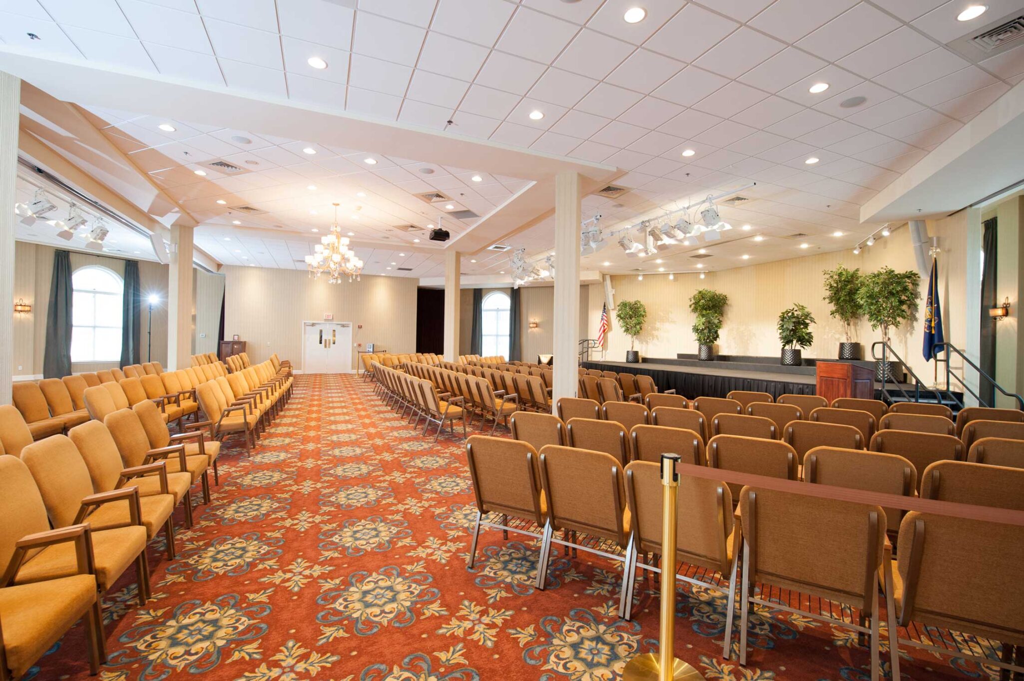 A wide shot of the empty medium sized auditorium at the senior living community