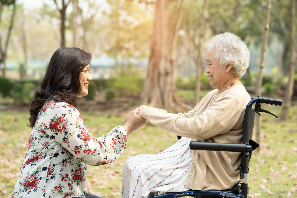 senior woman and her caregiver at a park