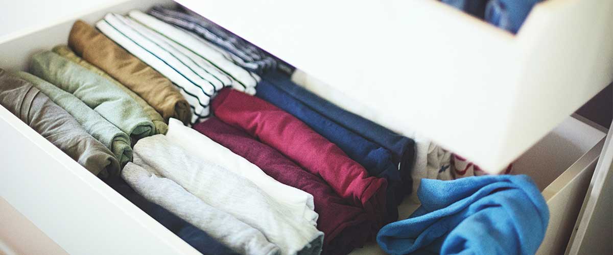 clothing folded neatly in a drawer