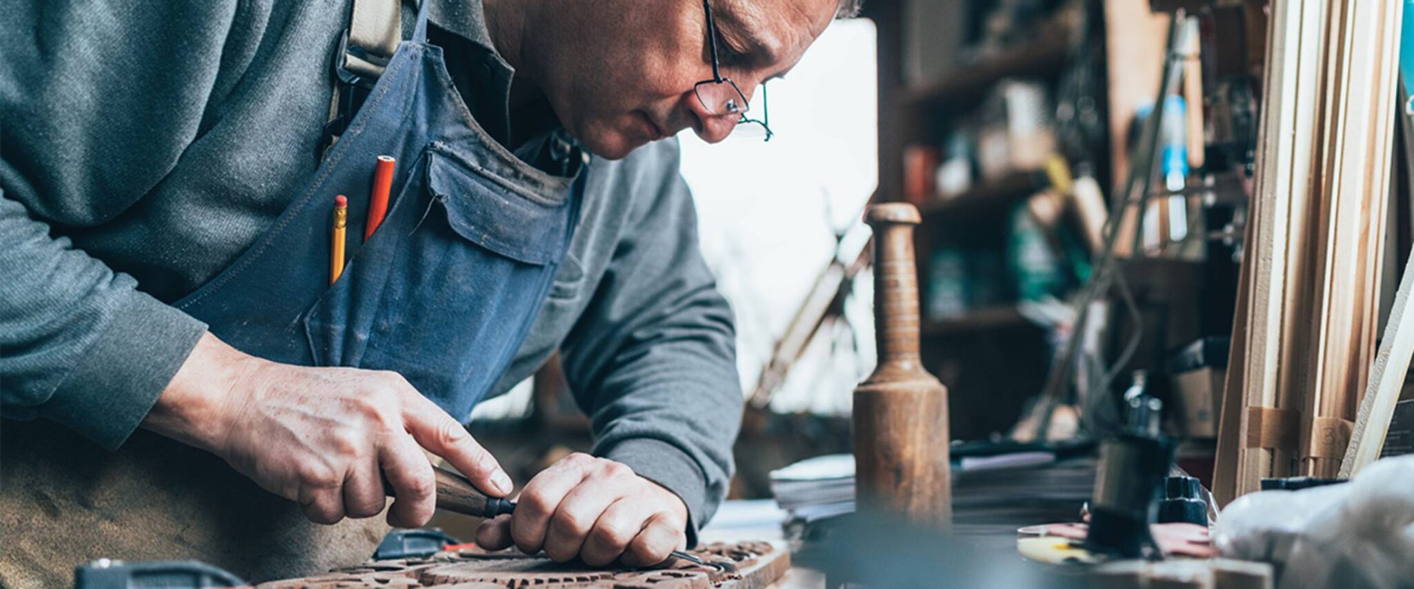 Senior man woodworking at his retirement home