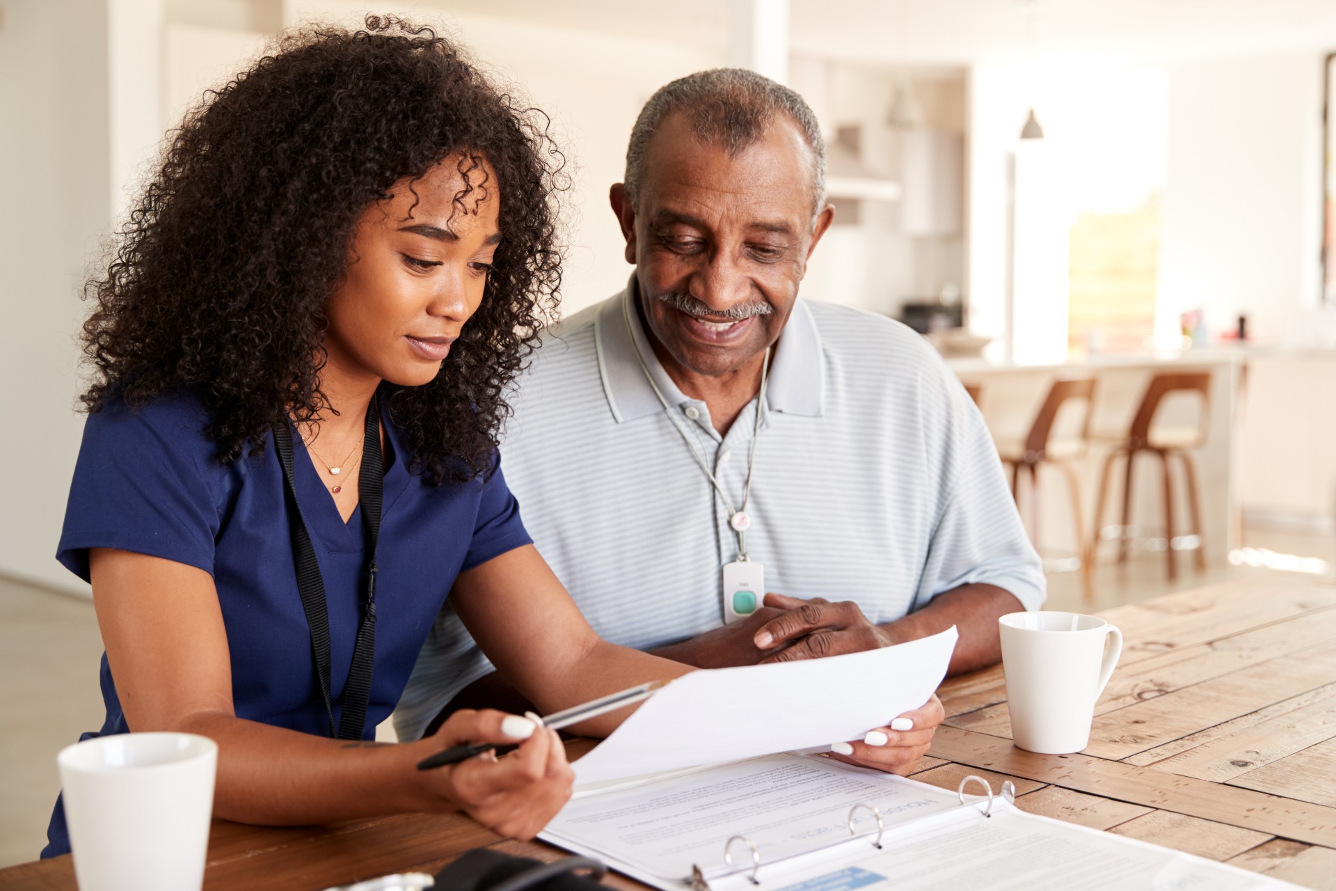 Female healthcare worker checking test results with a senior man