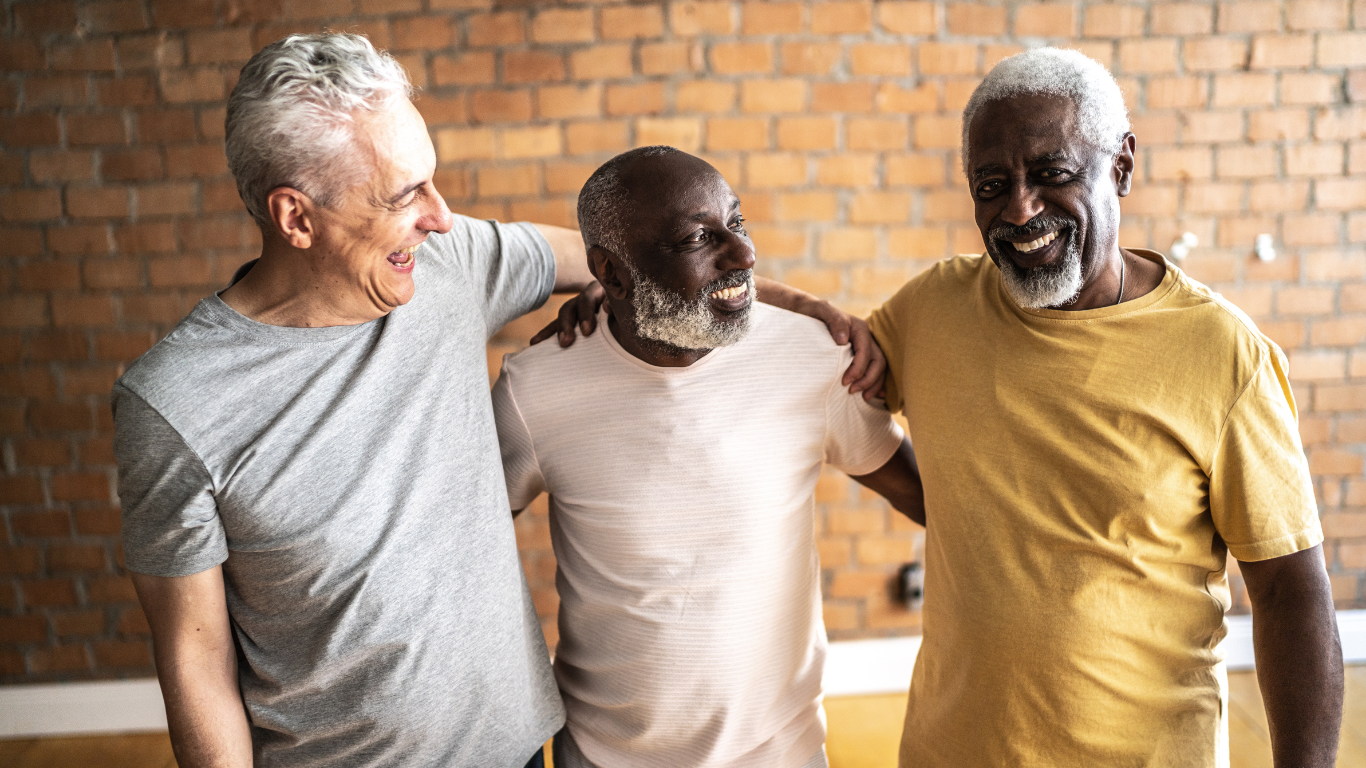 Group of smiling senior friends embracing each other