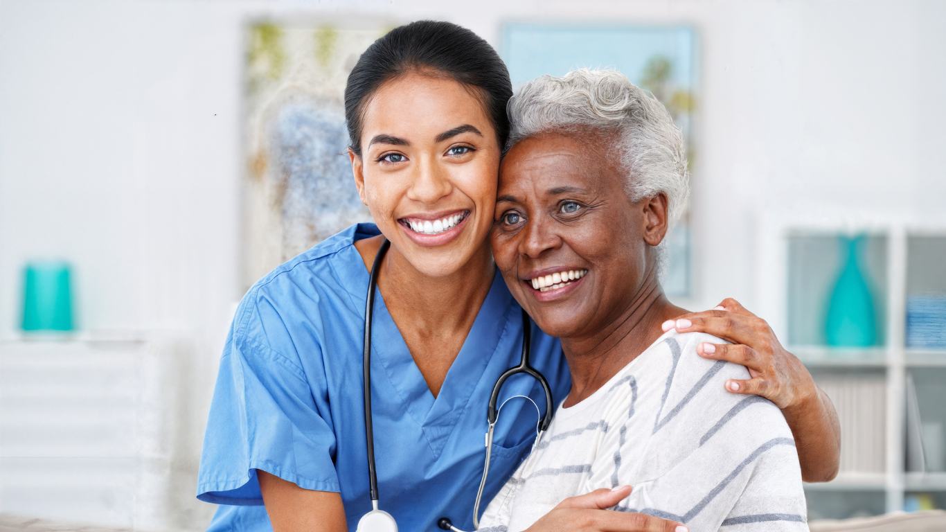 A health care worker hugs a senior woman