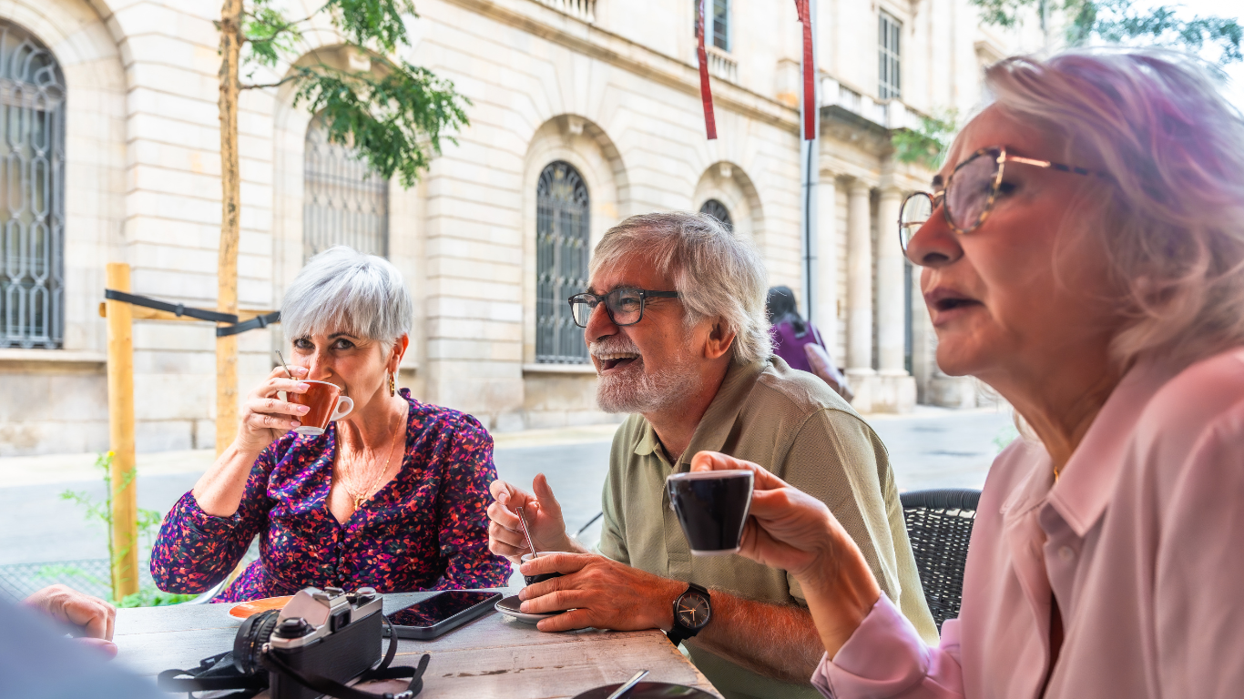 Group of seniors drinking coffee and talking together