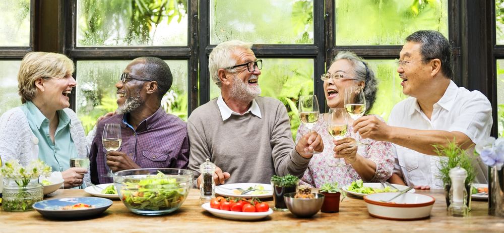 Group of senior friends enjoy dining together
