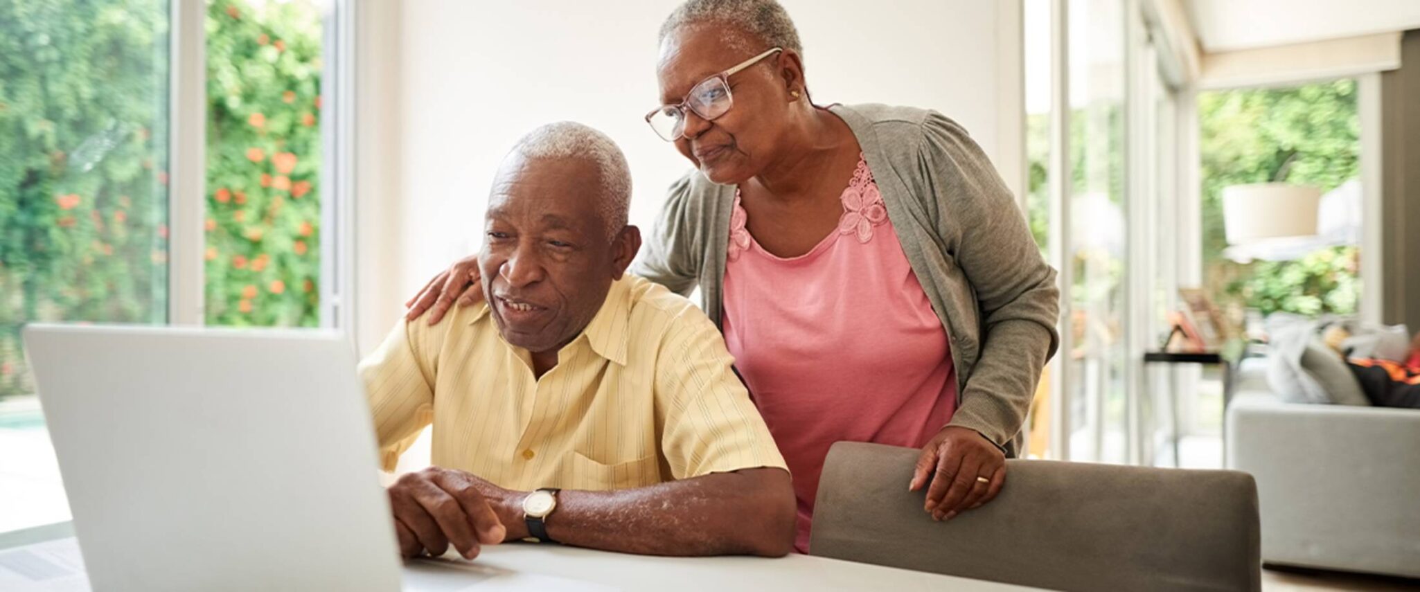 senior couple looking at senior living options on a laptop