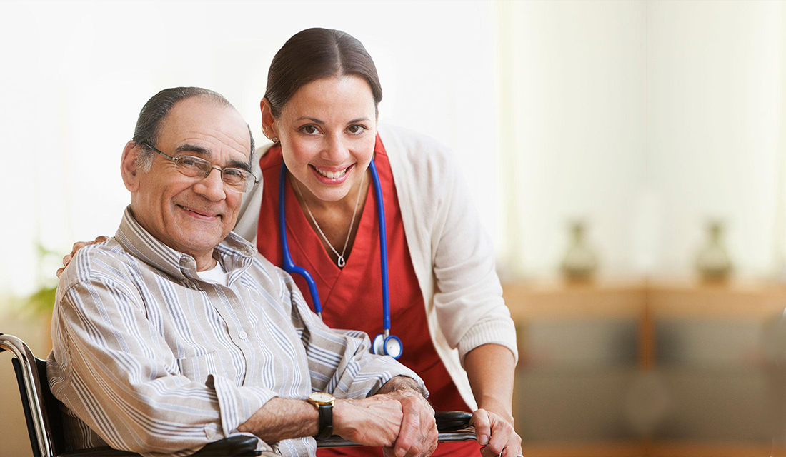nurse smiling with patient in wheel chair