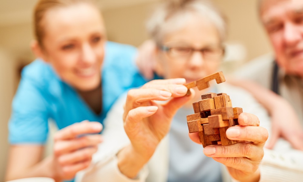 senior woman puts blocks of wood together